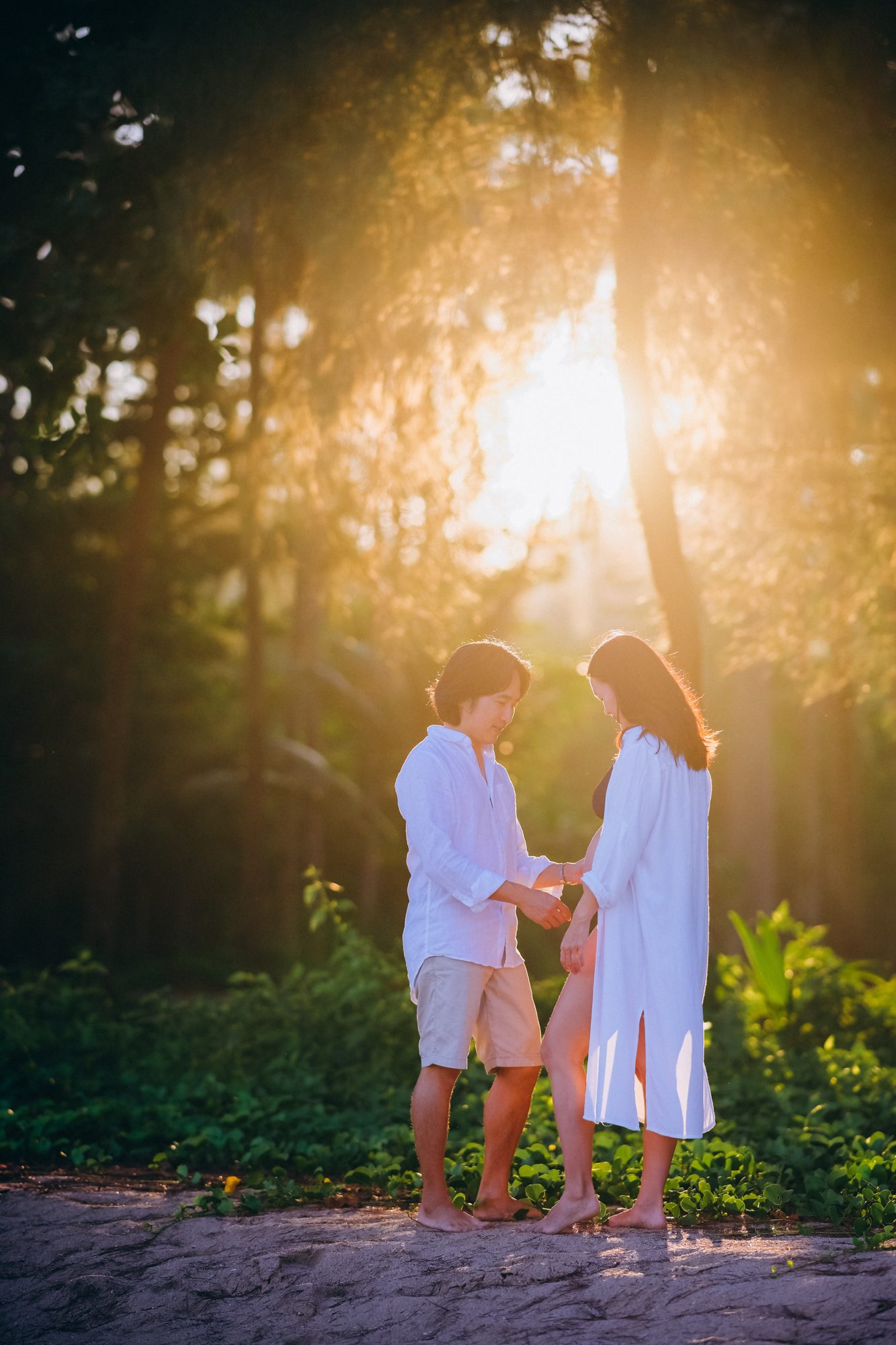 Backlit couple portrait in a forest near Khao Lak