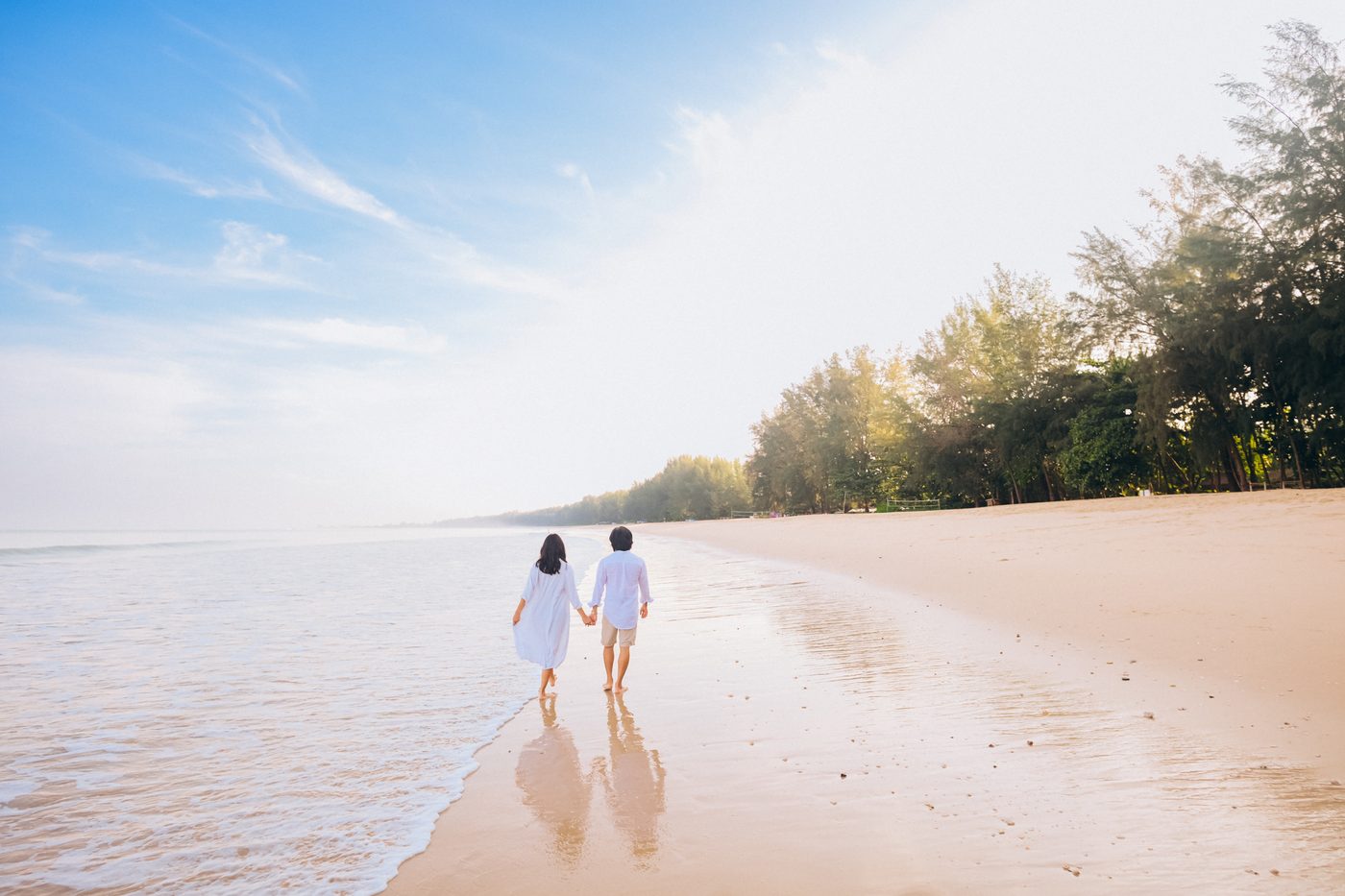 Couple walking along the coastline in Khao Lak