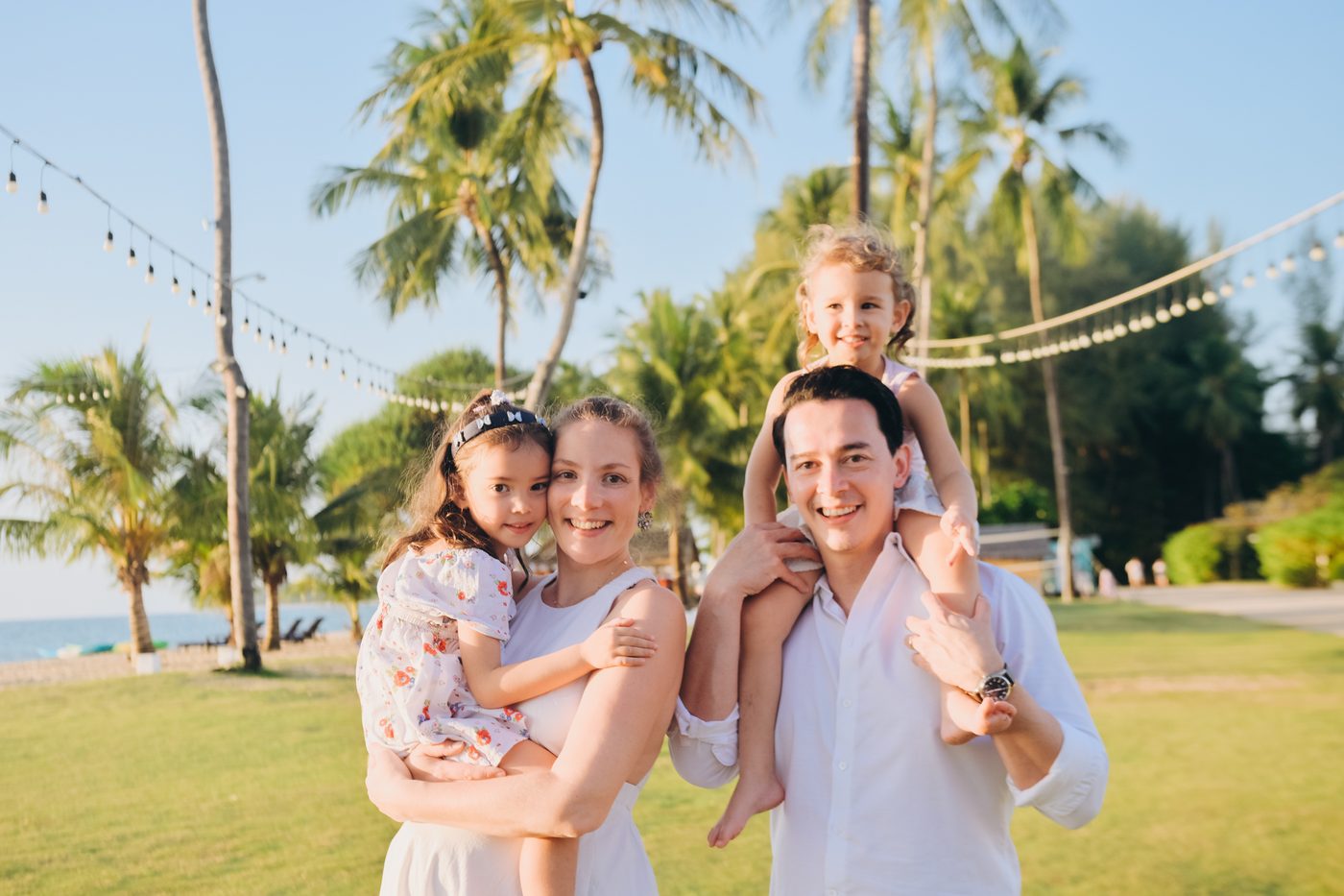 Family portrait session under evening string lights in Khao Lak