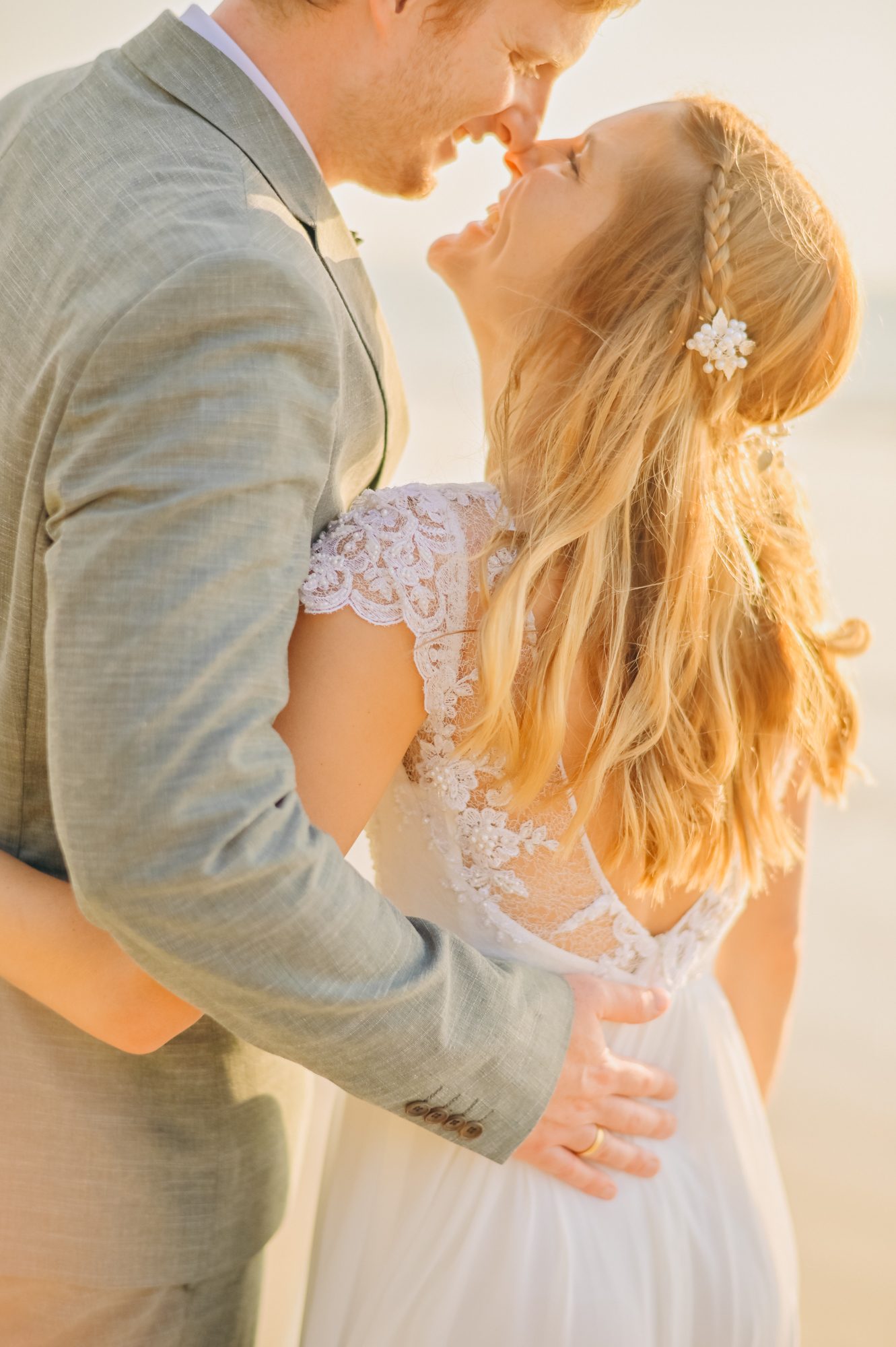 Honeymoon couple forehead to forehead on the beach in Khao Lak