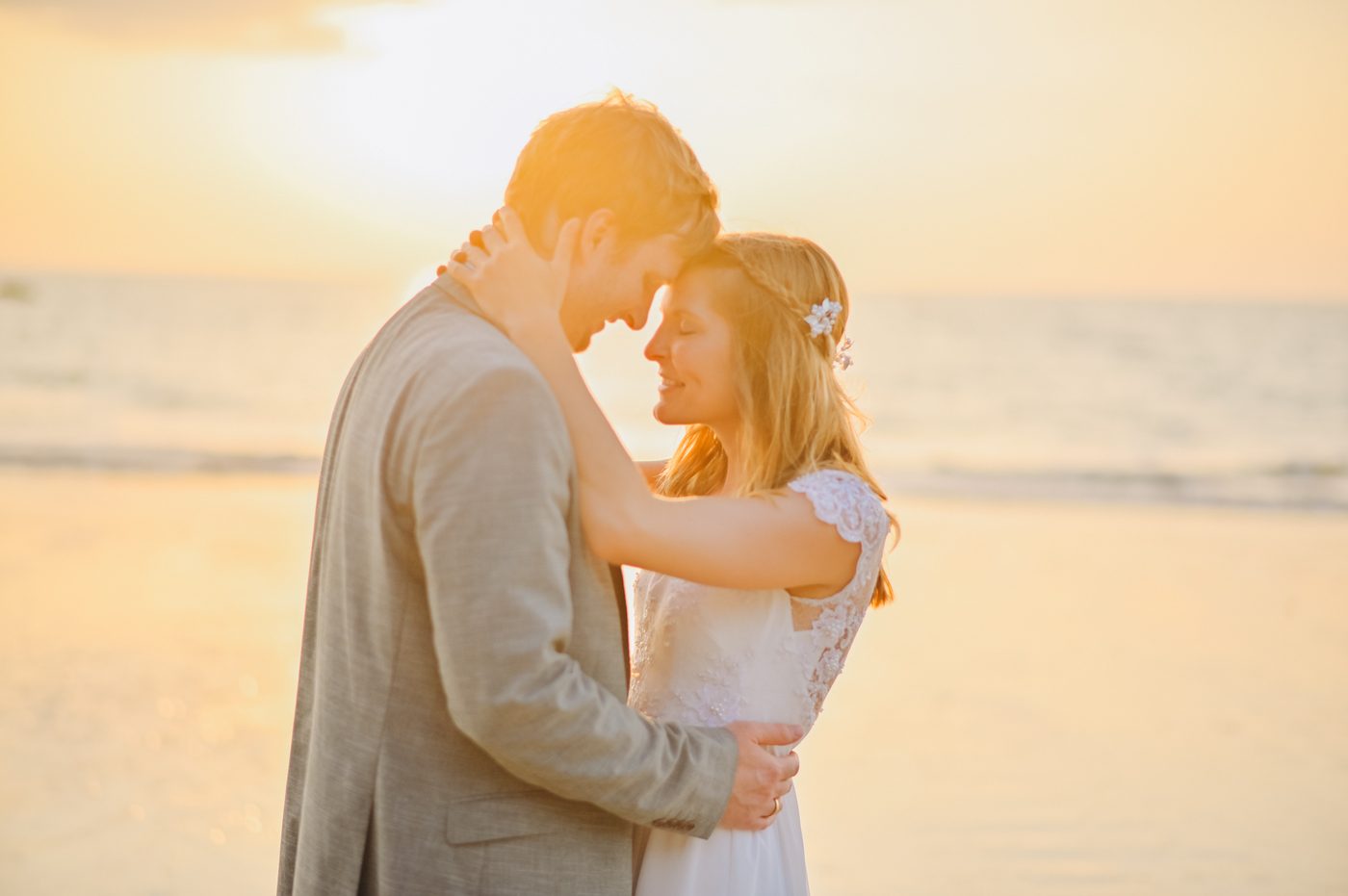 Wedding couple embracing at sunset in Khao Lak